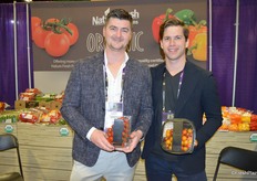Matt Quiring and Conor Chilvers with Nature Fresh Farms proudly show tomatoes in premium black label packaging. Matt shows tomatoes-in-the vine while Conor shows a medley, a new product.